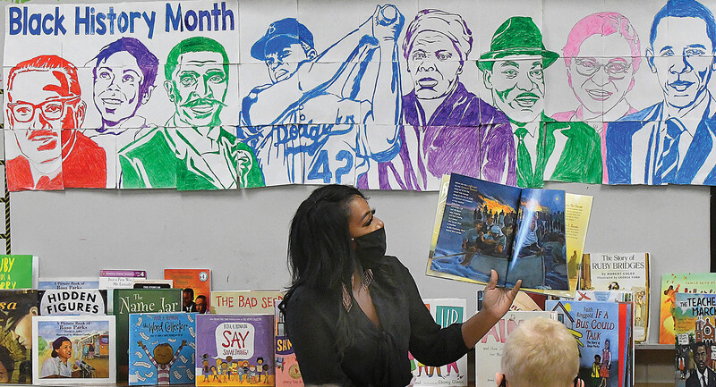 A teacher in Grove Elementary School in Illinois reads a book about Harriet Tubman to her 3rd grade student