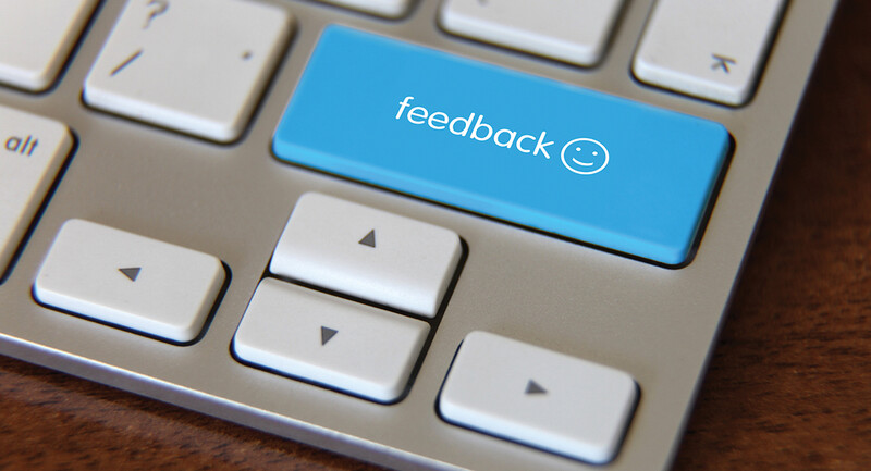 photo of a computer keyboard with a large blue button labeled "feedback"