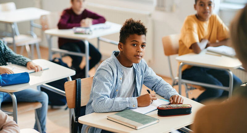Photo of a young Black student looking engaged in class