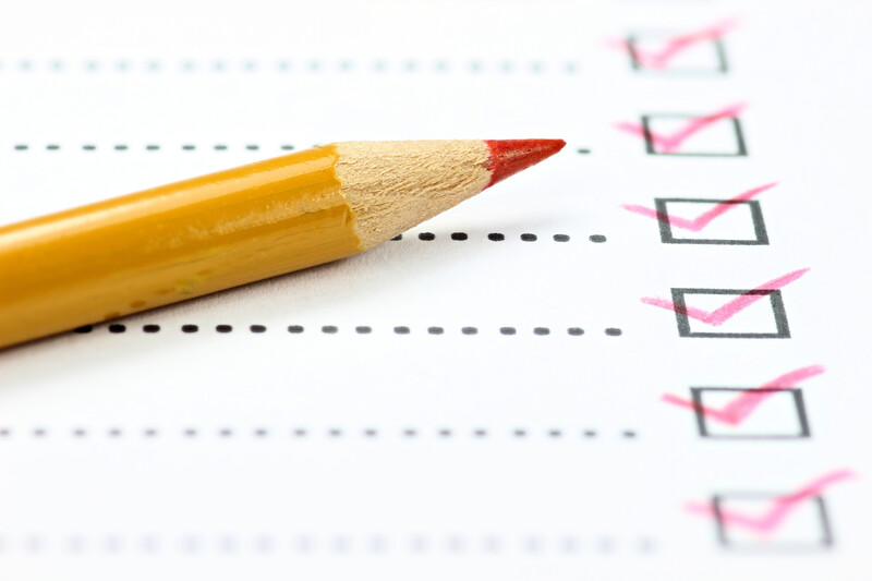 Photo of a pencil lying on a page of check boxes