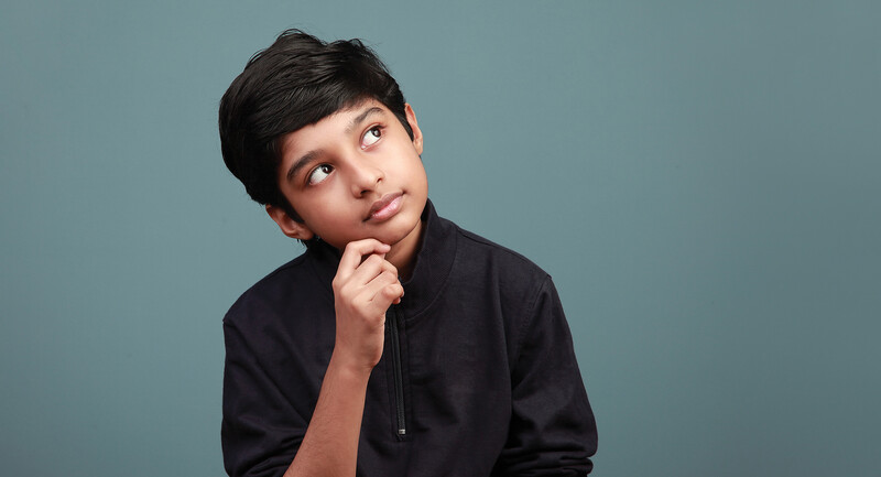 Photo of a young boy looking thoughtful